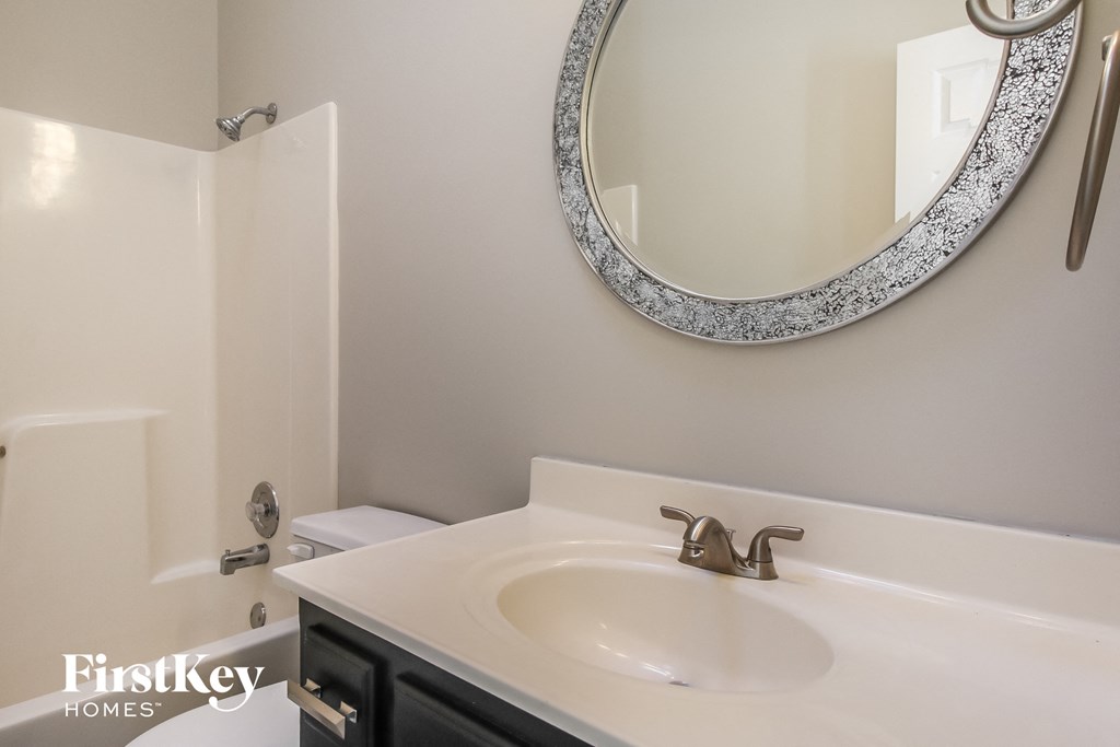 a small bathroom with a sink and a mirror