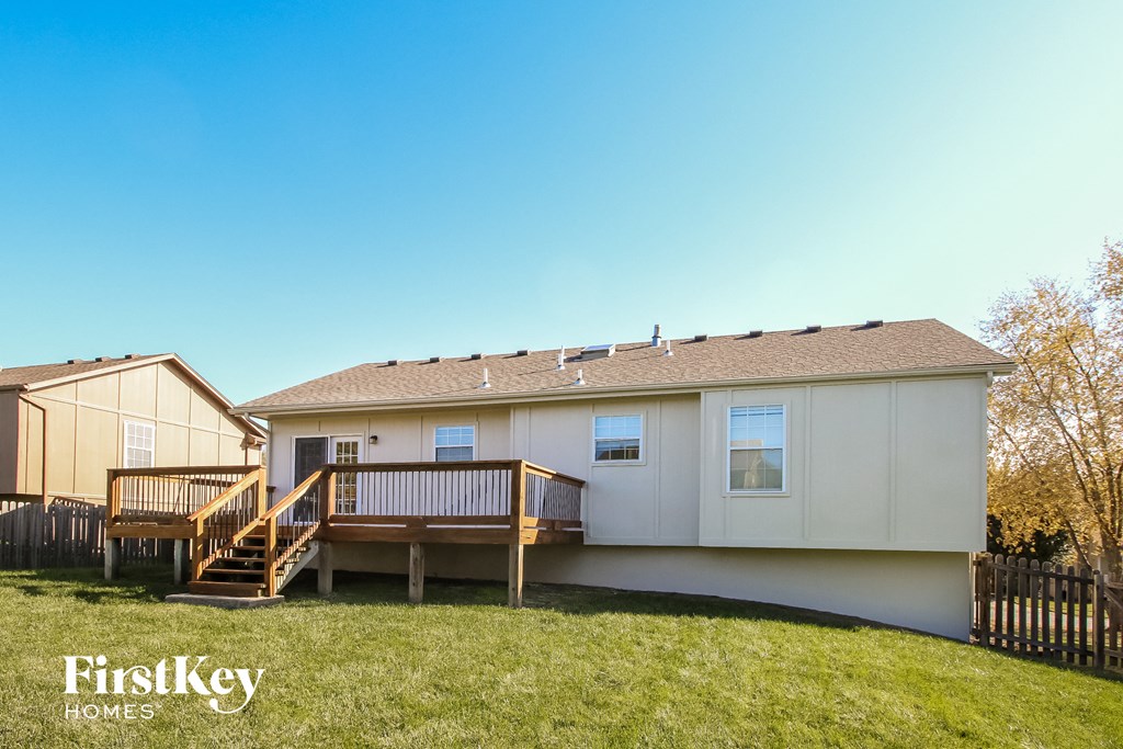 the exterior of a white manufactured home with a deck and a porch