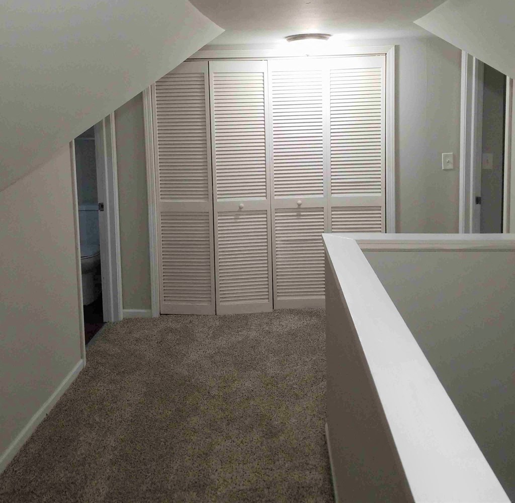 a large closet in a room with a carpeted floor