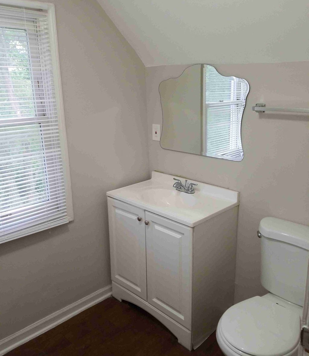 a small bathroom with a sink toilet and a mirror