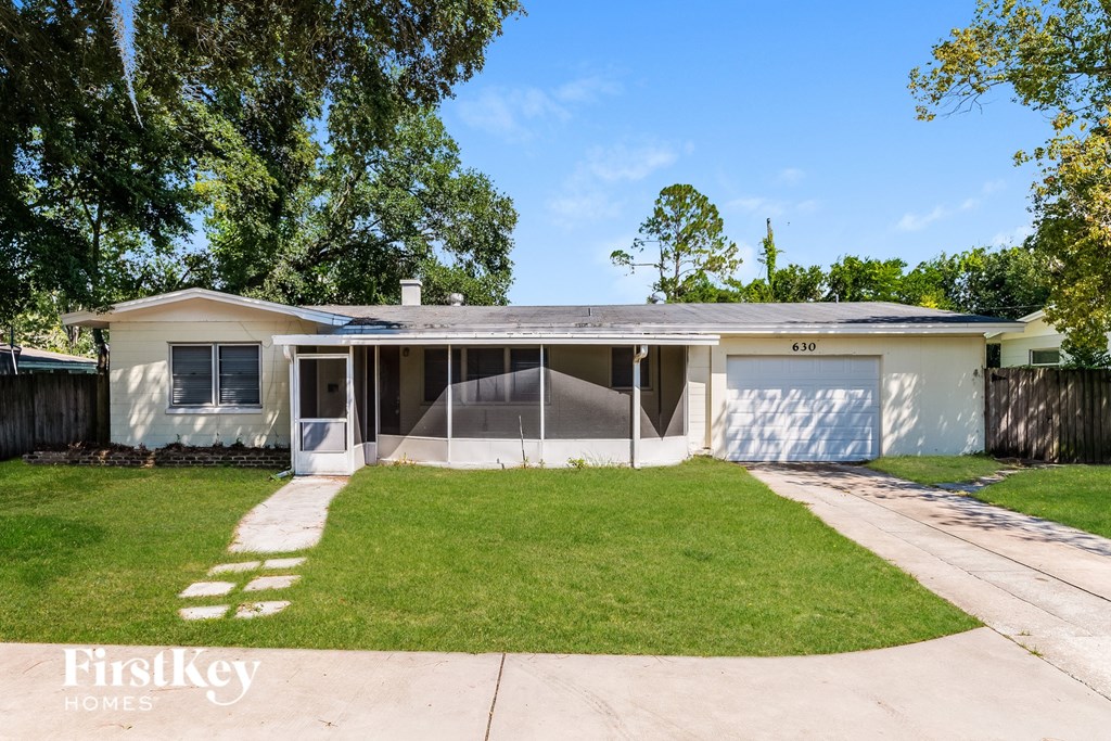 A house with a garage and a driveway is for sale.