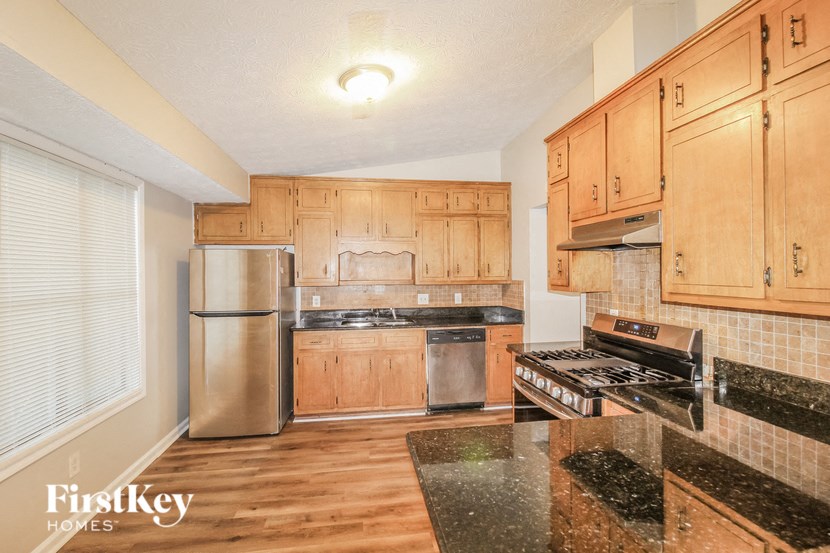a kitchen with granite counter tops and stainless steel appliances