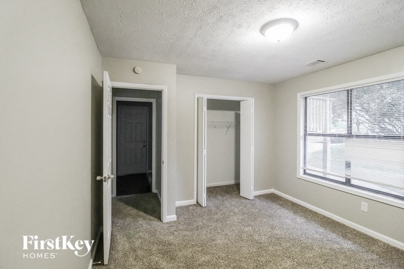 the living room of an empty house with a large window