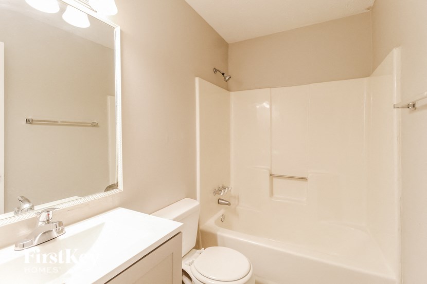 a white bathroom with a sink toilet and tub
