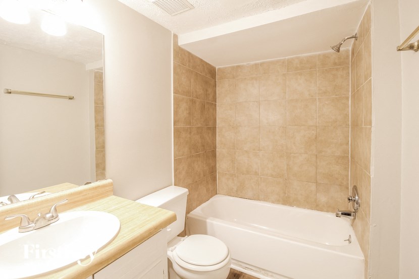 a bathroom with a sink toilet and a bath tub