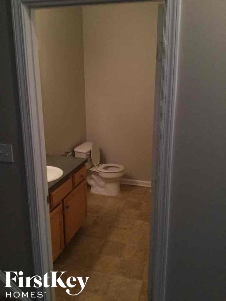 A bathroom with a toilet and sink.