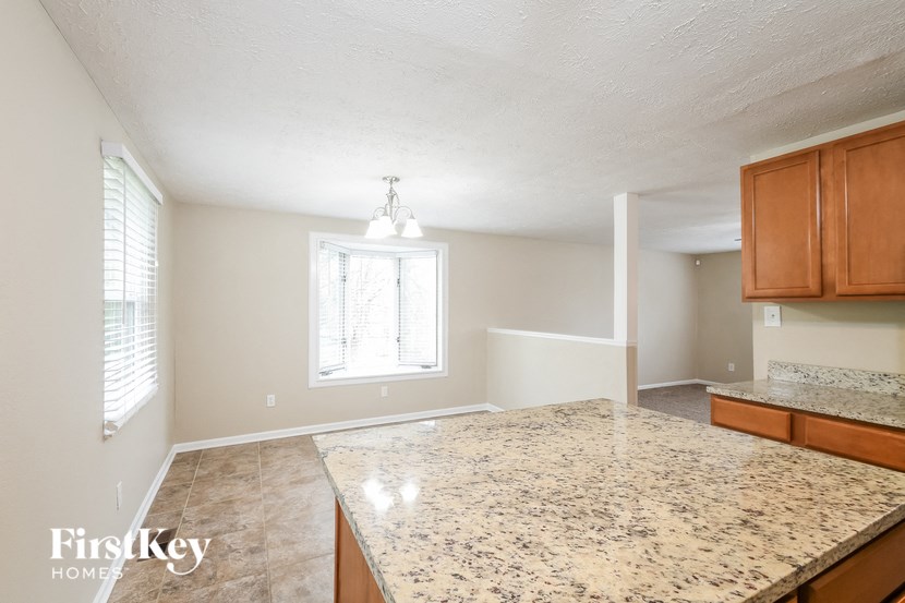 an empty kitchen with an island in the center