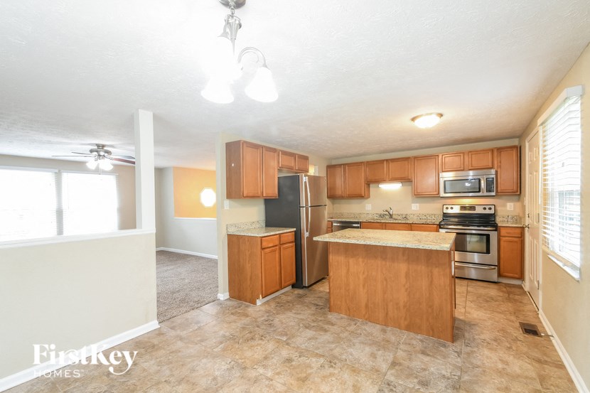 a kitchen with wooden cabinets and stainless steel appliances