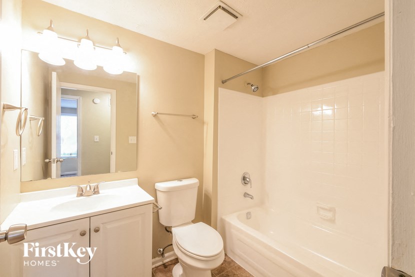 a bathroom with a toilet and a sink and a tub