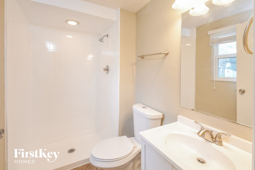 a bathroom with a toilet and a sink and a shower