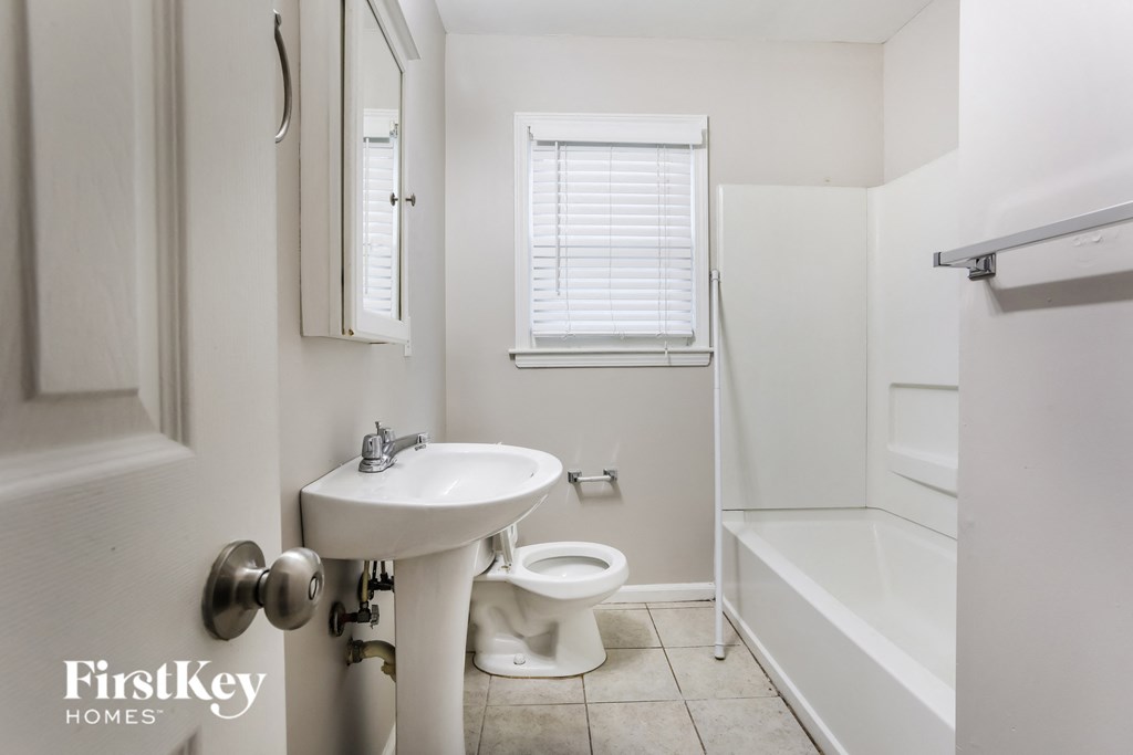 a bathroom with a sink and a toilet and a tub
