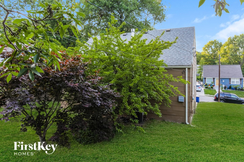 a backyard with a garage and a house