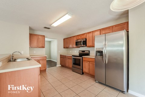 a kitchen with stainless steel appliances and wooden cabinets