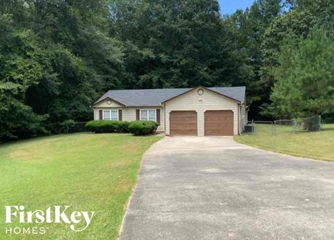 A house with a driveway and garage is for sale.