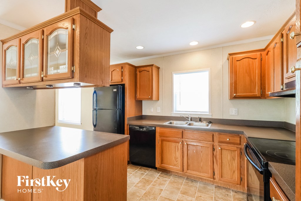 a kitchen with wooden cabinets and black appliances