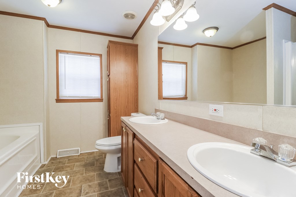 a bathroom with a sink and a toilet and a bath tub
