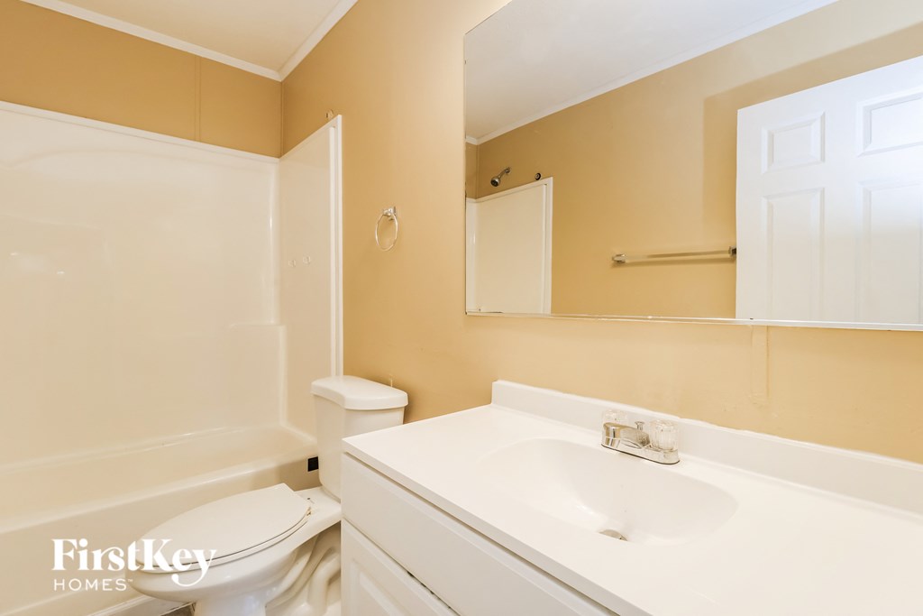 a bathroom with a white sink and a toilet