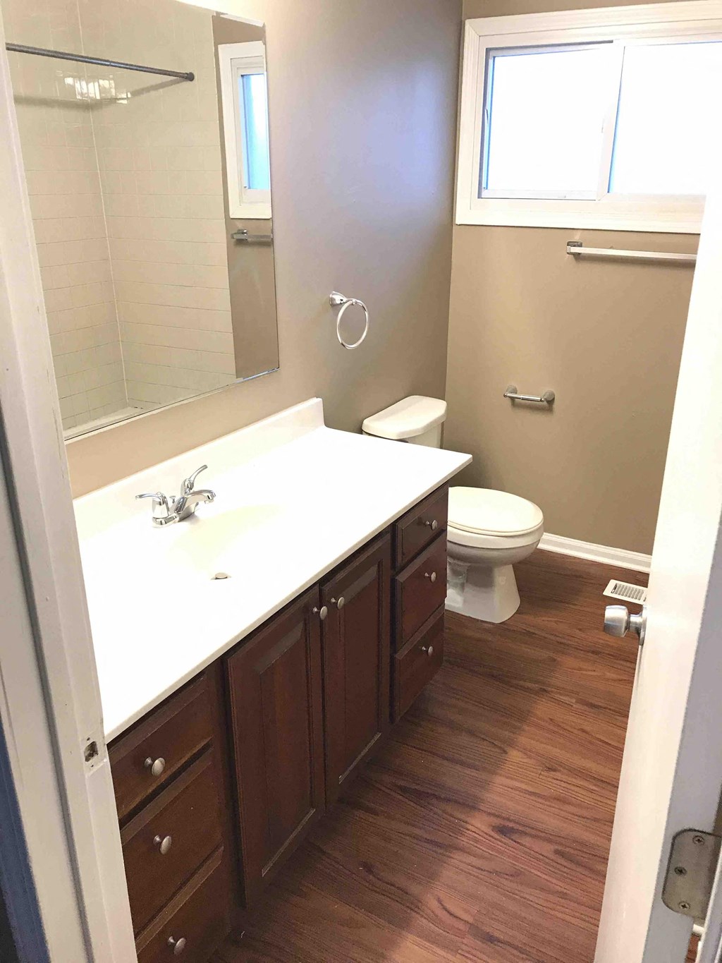 a bathroom with a toilet and a sink and a mirror