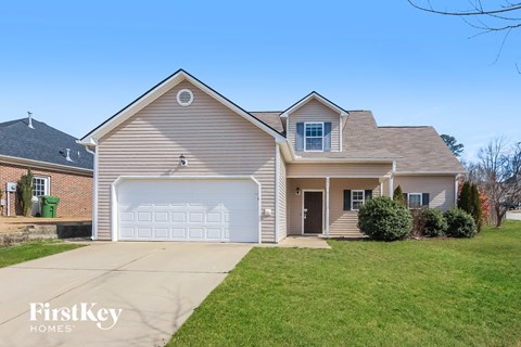 a beige house with a white garage door