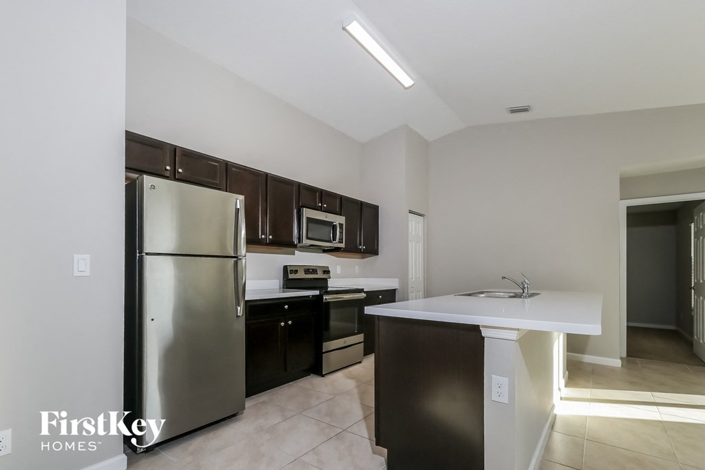 a kitchen with stainless steel appliances and a white counter top