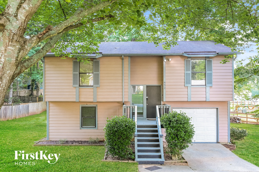 a pink house with a tree in front of it