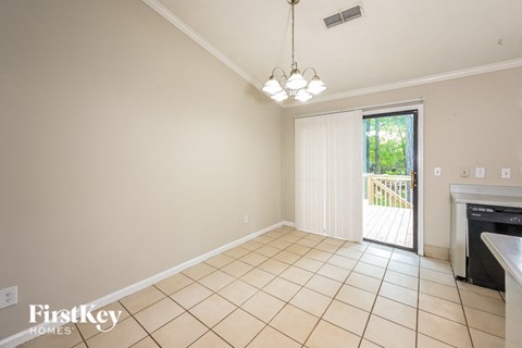 an empty living room with a sliding glass door to a patio