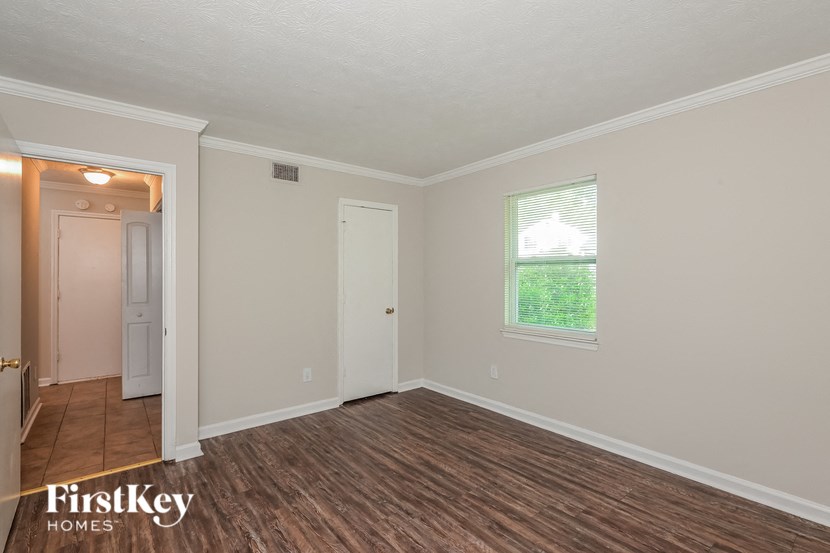 the living room of an empty house with a wooden floor