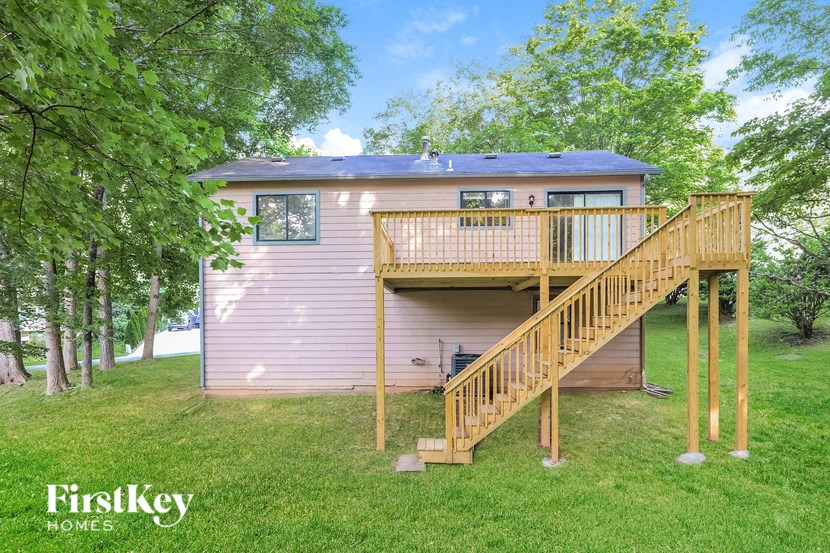 a house with a wooden deck on top of a