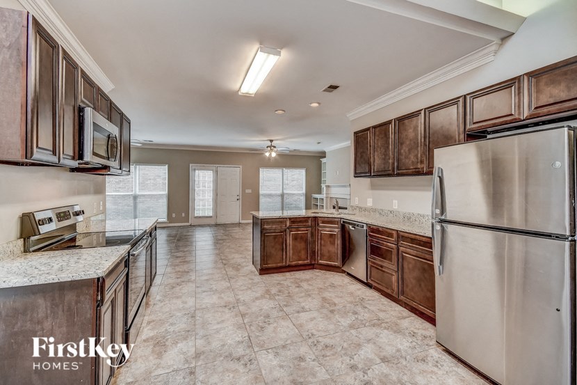 a kitchen with wooden cabinets and stainless steel appliances