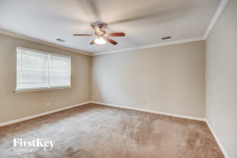 a bedroom with a ceiling fan and a window