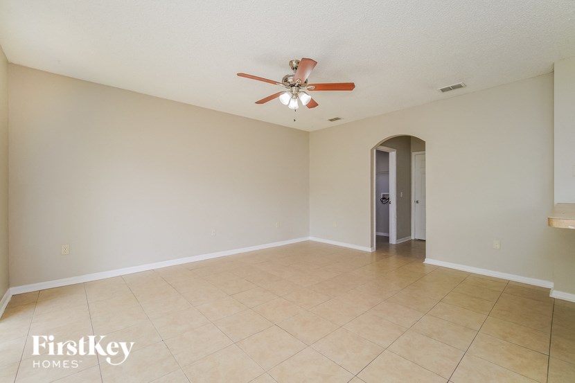 A room with a fan and a door in it.