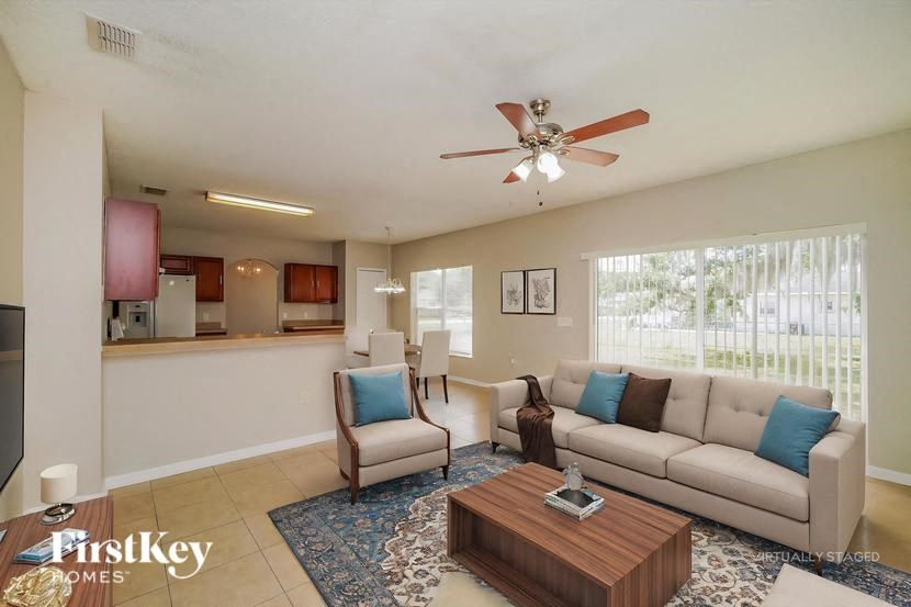 A living room with a couch, chairs, and a coffee table.