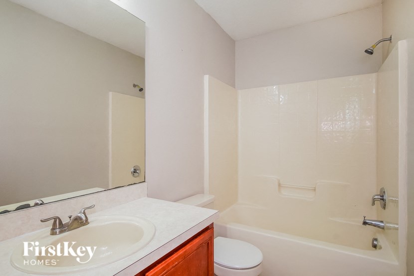 A white sink in a bathroom with a FirstKey Homes logo.
