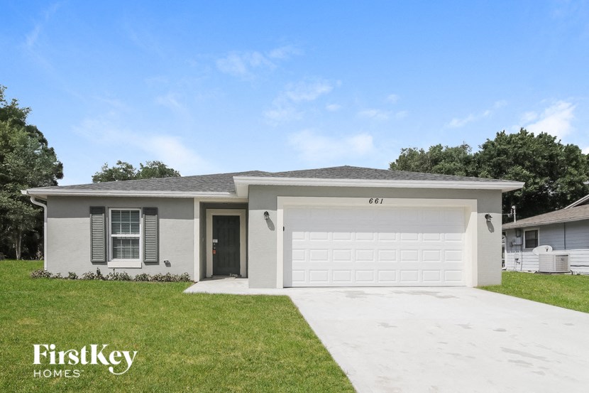 A house with a garage and a driveway is for sale.