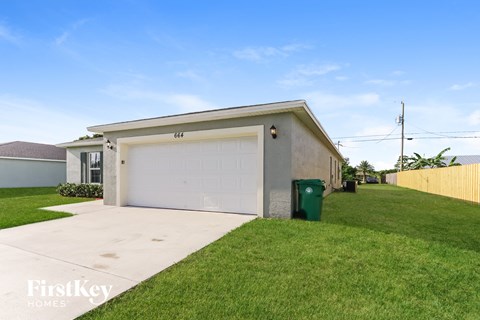 a home with a white garage door and a driveway