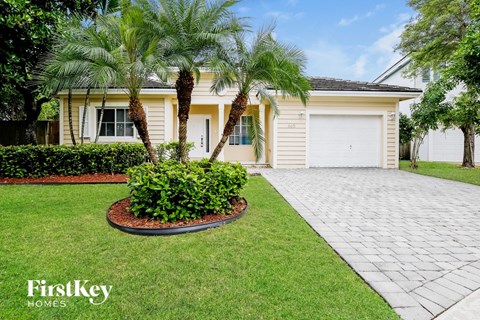 A house with a palm tree in front of it.