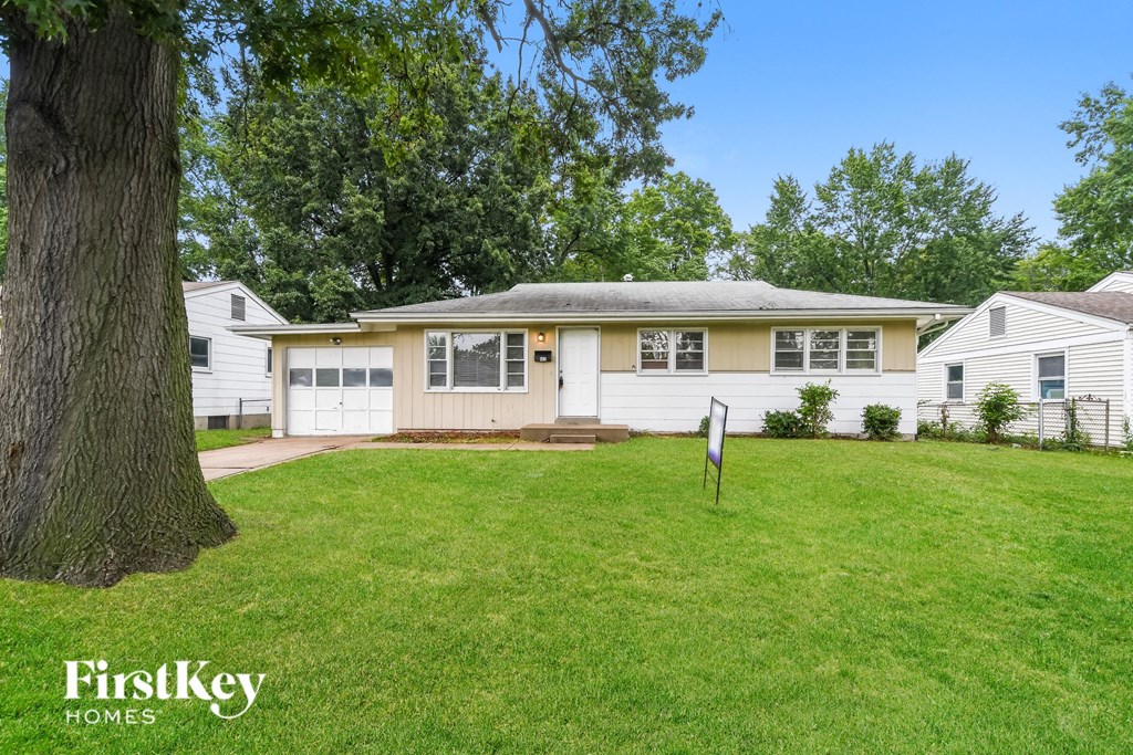 a white house with a yard in front of it