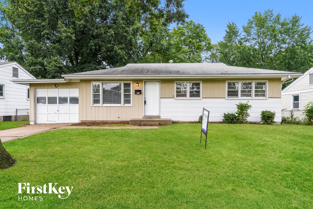 a white house with a lawn in front of it