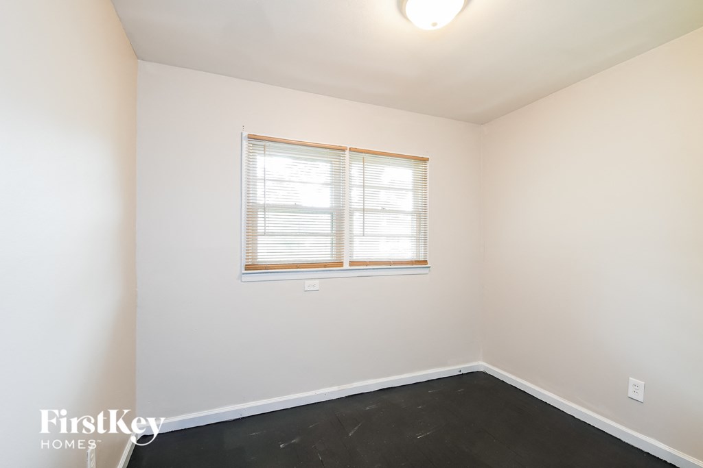 a white room with a window and a black floor