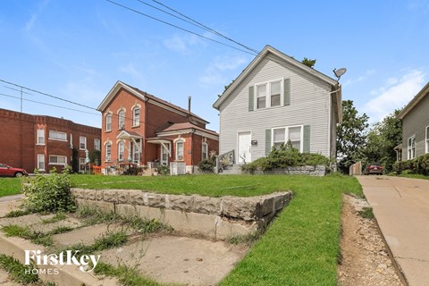 A row of houses with a stone wall in the foreground.