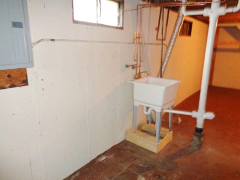 a bathroom with a sink in the corner