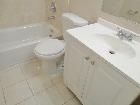 a bathroom with a toilet and a sink and a bath tub
