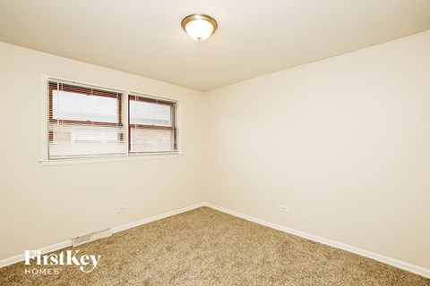 the upstairs bedroom has carpet and a window