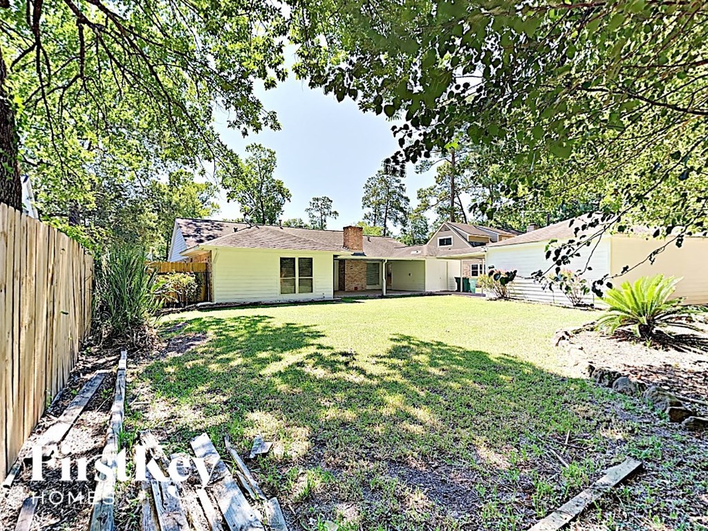 a backyard with a house and a yard with grass and trees