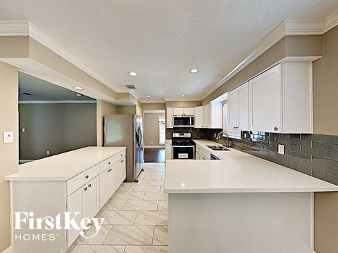 a large white kitchen with white counters and white cabinets