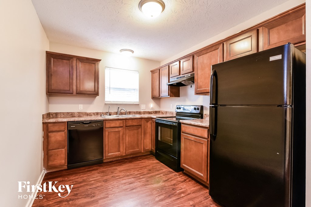 a kitchen with black appliances and wooden cabinets