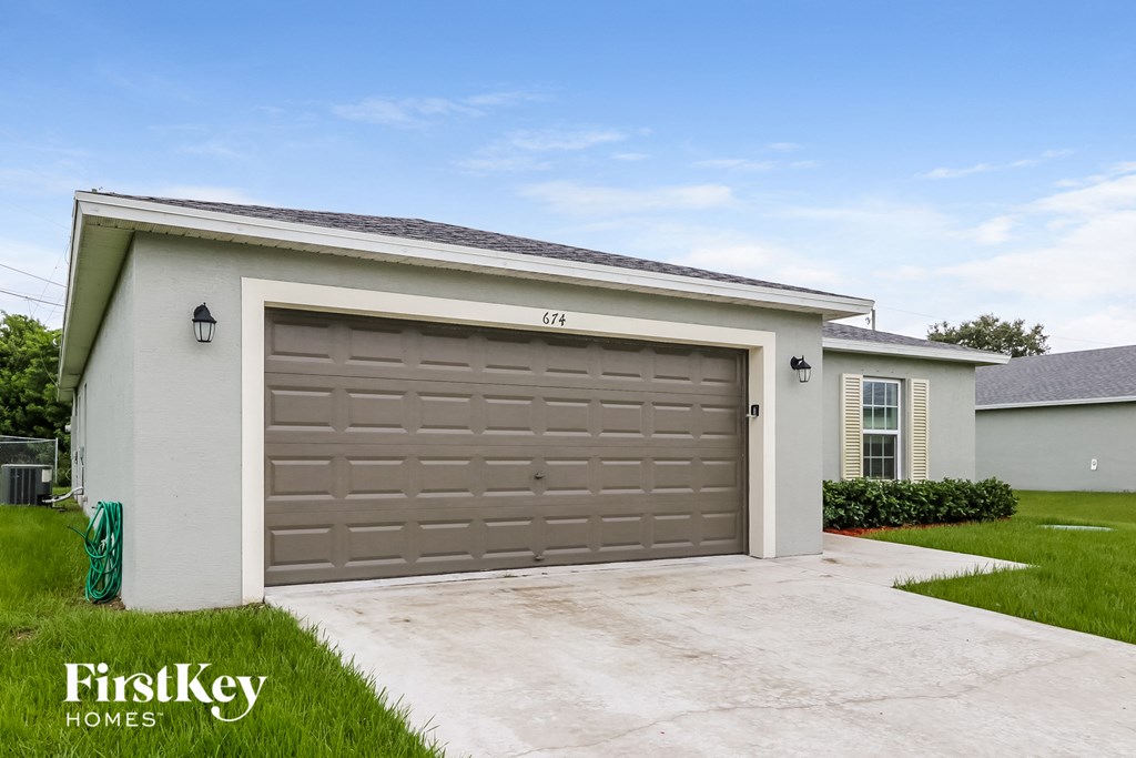 A house with a garage door that says 674 on it.
