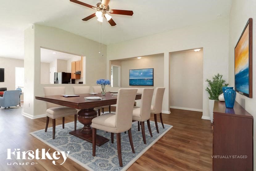A dining room with a wooden table and chairs.