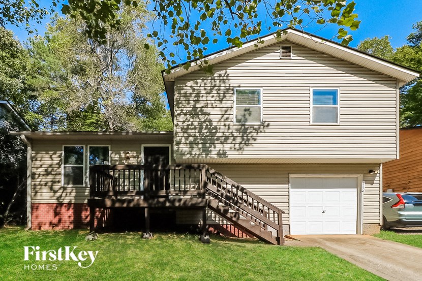 a white house with a deck and a garage