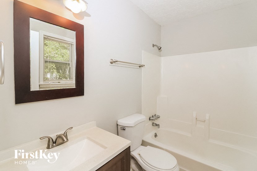 a bathroom with a sink toilet and a bath tub
